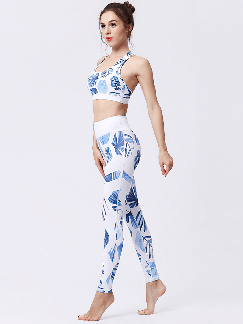 Woman wearing blue floral high-waist sports leggings set, showcasing stretch and comfort for yoga or fitness activities.
